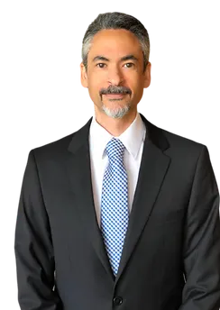 Stephen Thompson, a Physical Therapist, wearing a dark suit with a white shirt, and checkered tie, in a professional setting.